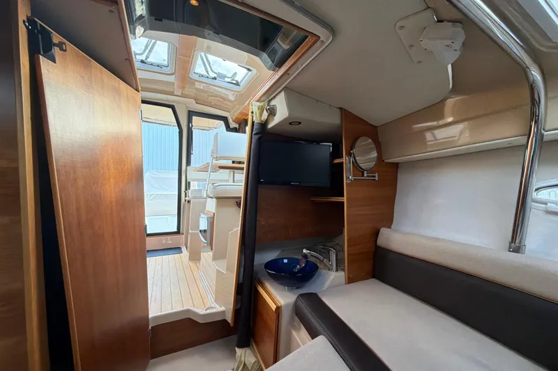 Slide: The Image of Interior of 2016 Cutwater C-242 Coupe boat, featuring cozy seating and modern amenities. - 39