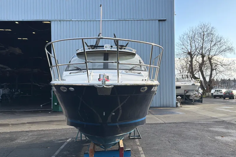Slide: The Image of 2016 Cutwater C-242 Coupe boat in front of a large warehouse. - 4