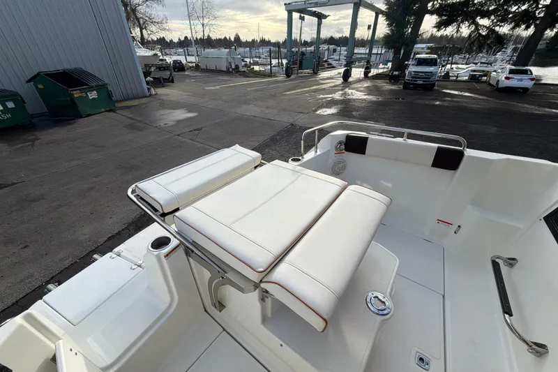 Slide: The Image of 2016 Cutwater C-242 Coupe boat interior with white seating at a marina. - 42