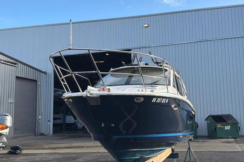 Slide: The Image of 2016 Cutwater C-242 Coupe boat docked outside a large warehouse. - 5