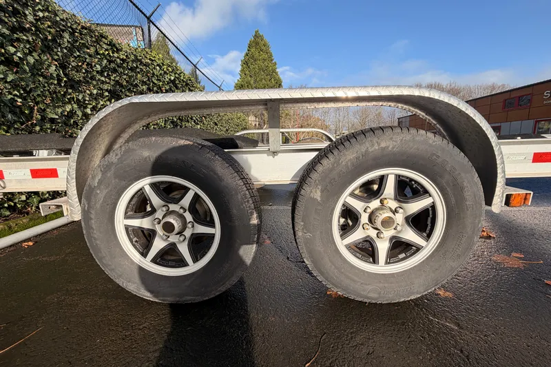 Slide: The Image of Trailer wheels on a Cutwater C-242 Coupe, 2016 model, parked on wet pavement. - 53