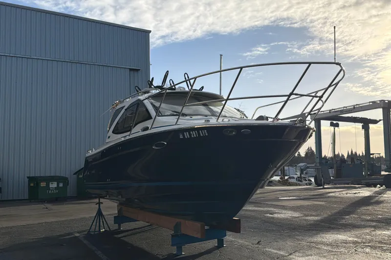 Slide: The Image of 2016 Cutwater C-242 Coupe boat on dry dock near industrial building. - 6