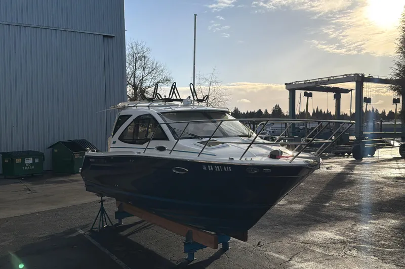 Slide: The Image of 2016 Cutwater C-242 Coupe boat on a stand, outdoor setting, sunny day. - 7