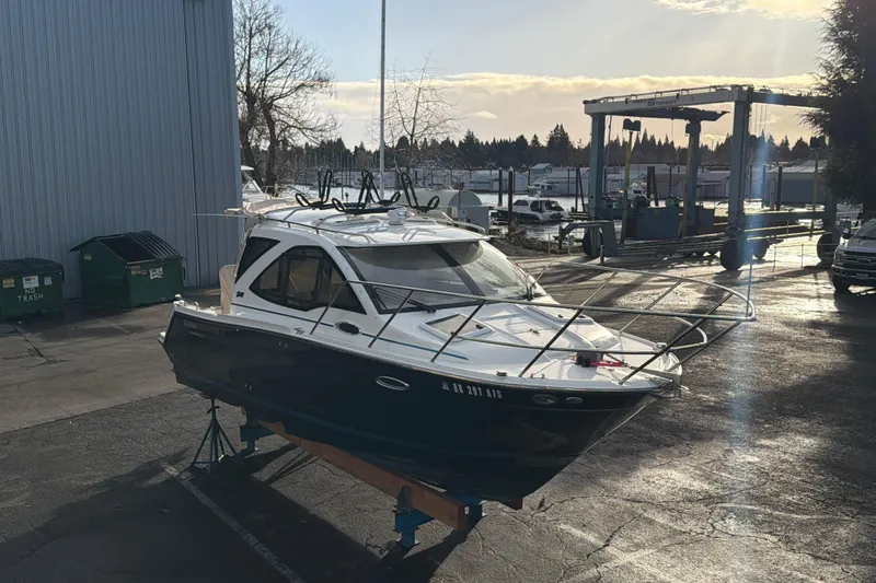 Slide: The Image of 2016 Cutwater C-242 Coupe boat on a stand in a marina setting. - 8
