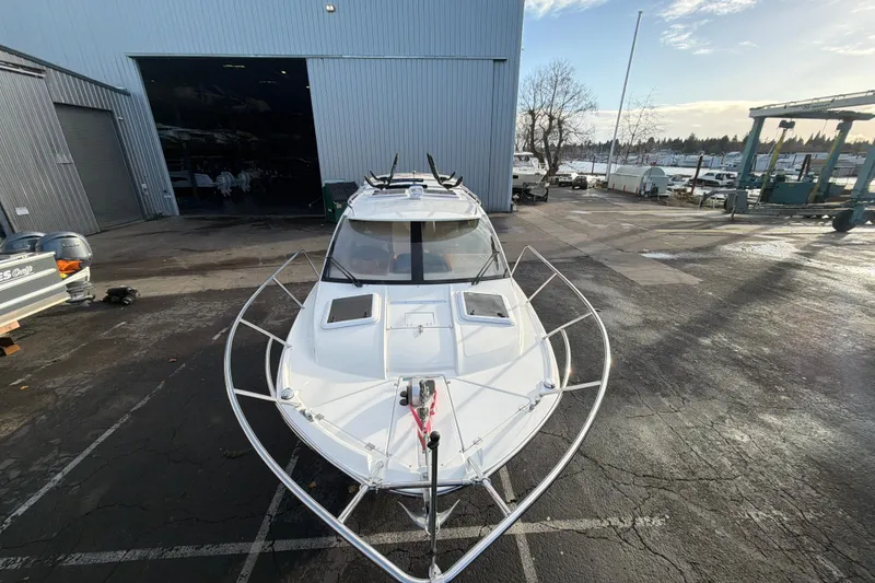 Slide: The Image of 2016 Cutwater C-242 Coupe boat docked outside a large warehouse. - 9