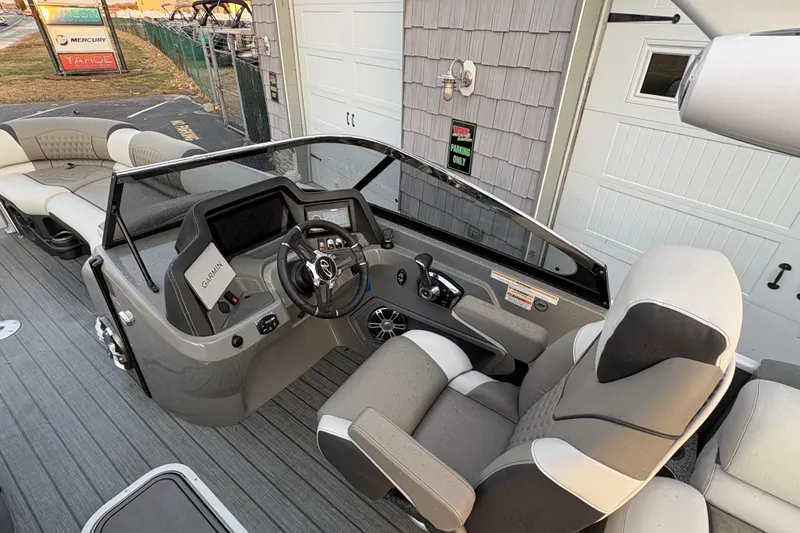 Slide: The Image of 2023 Avalon Excalibur 2585 Windshield Elite boat interior with modern helm and seating. - 14