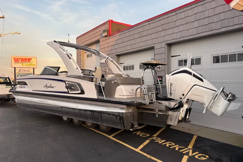 Slide: The Image of 2023 Avalon Excalibur 2585 Windshield Elite Tri Toon with Single 450R engine, parked outside. - 4