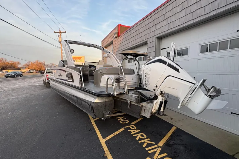 Slide: The Image of 2023 Avalon Excalibur 2585 Windshield Elite Tri Toon with Single 450R engine parked outside. - 5