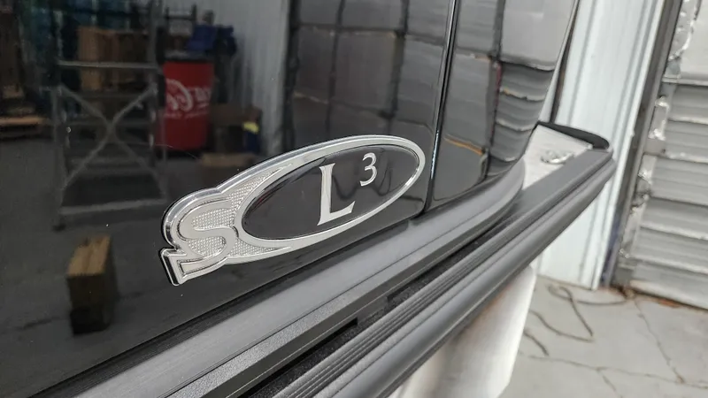 Slide: The Image of Close-up of the Sylvan L3 SLZ logo on a shiny black boat. - 43