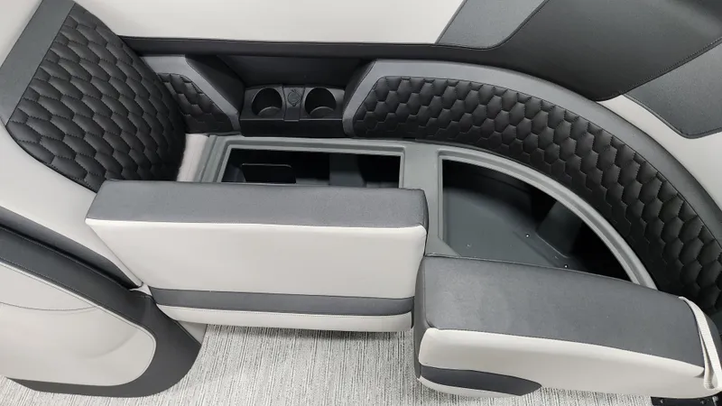 Slide: The Image of Interior of a Sylvan L3 SLZ boat with cushioned seating and cup holders. - 38
