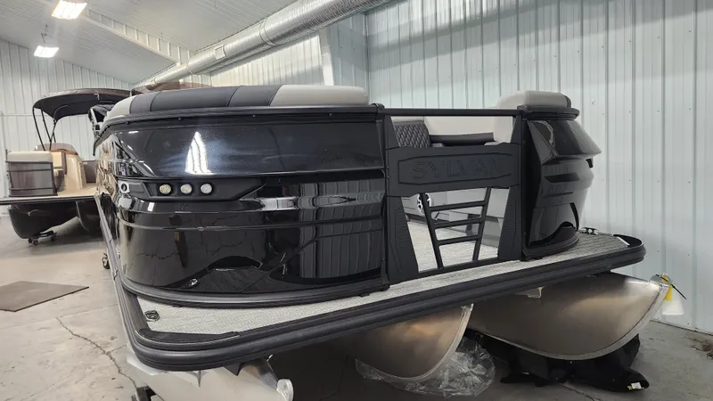 Slide: The Image of A 2026 Sylvan L3 SLZ pontoon boat in a storage facility. - 42