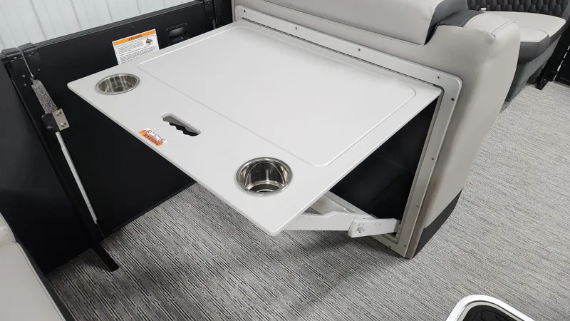 Slide: The Image of A fold-out table with cup holders in a Sylvan L3 SLZ boat. - 22