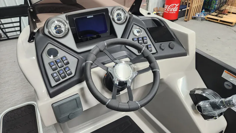 Slide: The Image of The image shows the helm of a Sylvan L3 SLZ boat with modern instruments and a steering wheel. - 31