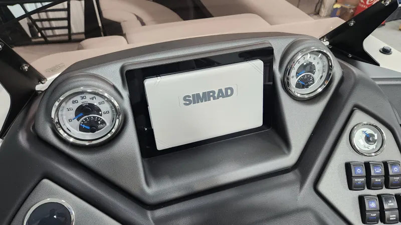 Slide: The Image of The dashboard of a 2026 Sylvan L3 SLZ with a Simrad screen and gauges. - 25