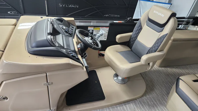 Slide: The Image of The image shows the helm of a Sylvan L3 DLZ boat with a cushioned captain's chair. - 13