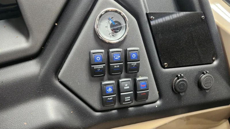 Slide: The Image of Dashboard of a Sylvan L3 DLZ boat with switches and a compass. - 21