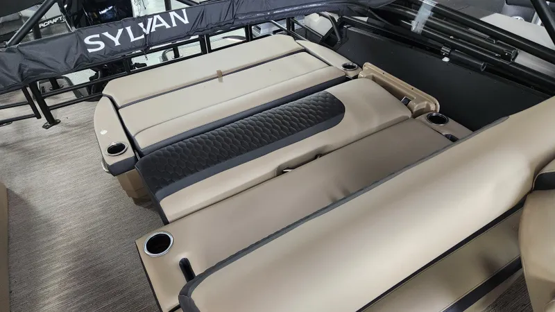 Slide: The Image of Interior view of a Sylvan L3 DLZ boat with beige upholstery and cup holders. - 26