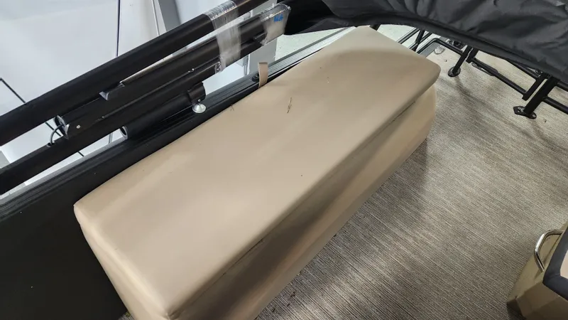 Slide: The Image of A beige bench seat on a boat with gray carpet flooring. - 27