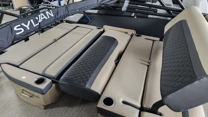 Slide: The Image of Interior view of a Sylvan L3 DLZ boat with beige and black seating and cup holders. - 28