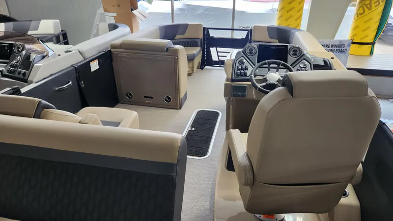 Slide: The Image of Interior of a Sylvan L3 DLZ pontoon boat with beige seating and a modern helm. - 33