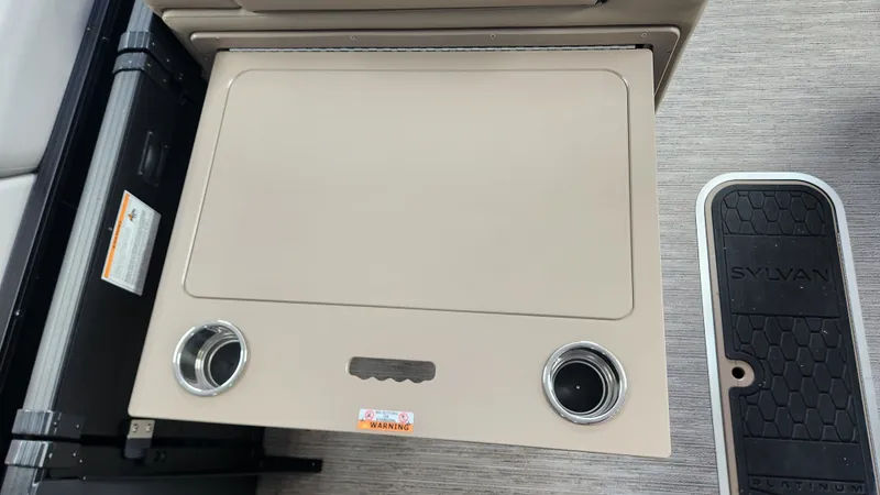 Slide: The Image of A table with cup holders on a Sylvan L3 DLZ boat. - 37