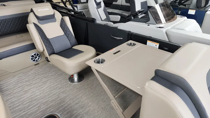 Slide: The Image of Interior of a 2026 Sylvan L3 DLZ with beige seating and a foldable table. - 38