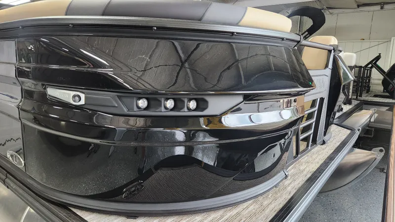 Slide: The Image of The image shows the sleek black stern of a Sylvan L3 DLZ pontoon boat. - 43