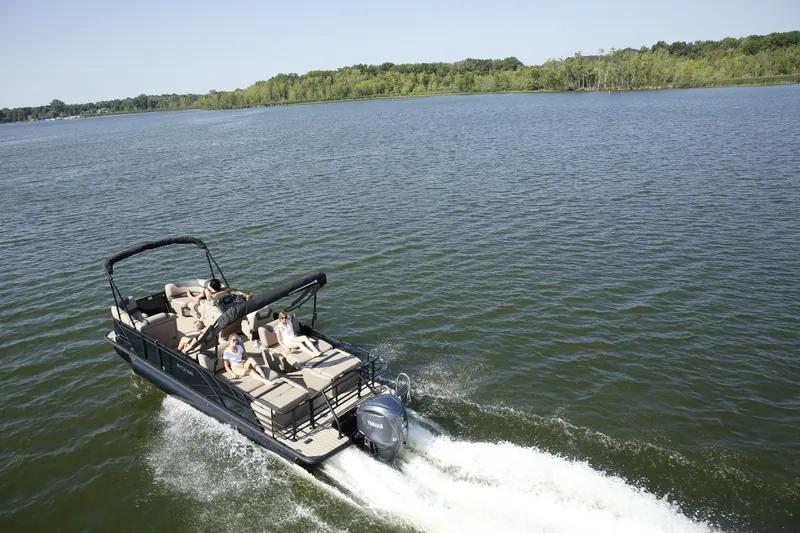 Slide: The Image of Sylvan L-3 RLZ 2026 pontoon boat cruising on a serene lake. - 4