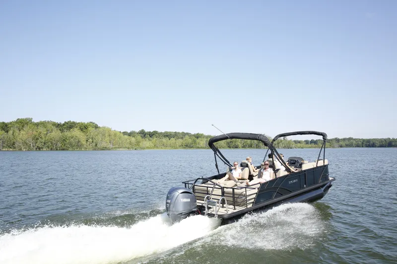 Slide: The Image of 2026 Sylvan L-3 RLZ pontoon boat cruising on a serene lake. - 5