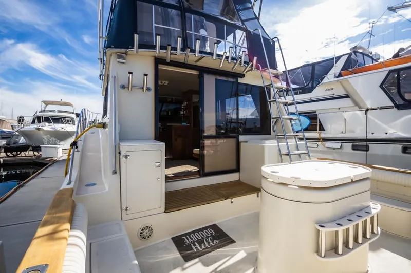 Slide: The Image of 1987 Californian 48 Convertible yacht docked at marina, rear view. - 10