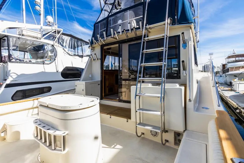 Slide: The Image of 1987 Californian 48 Convertible yacht stern view with ladder and open cabin door. - 11