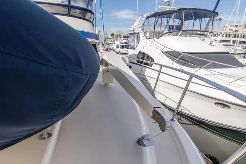 Slide: The Image of 1987 Californian 48 Convertible yacht docked at marina, side deck view. - 15