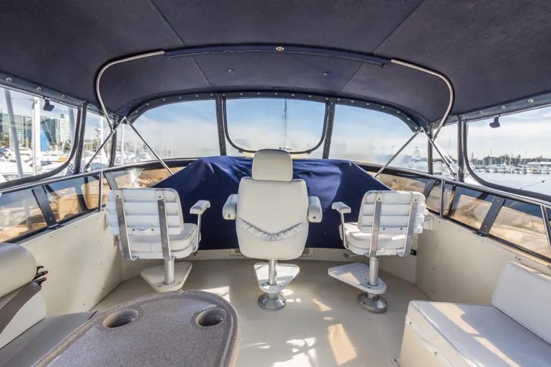Slide: The Image of 1987 Californian 48 Convertible yacht interior with captain's chairs and panoramic windows. - 18