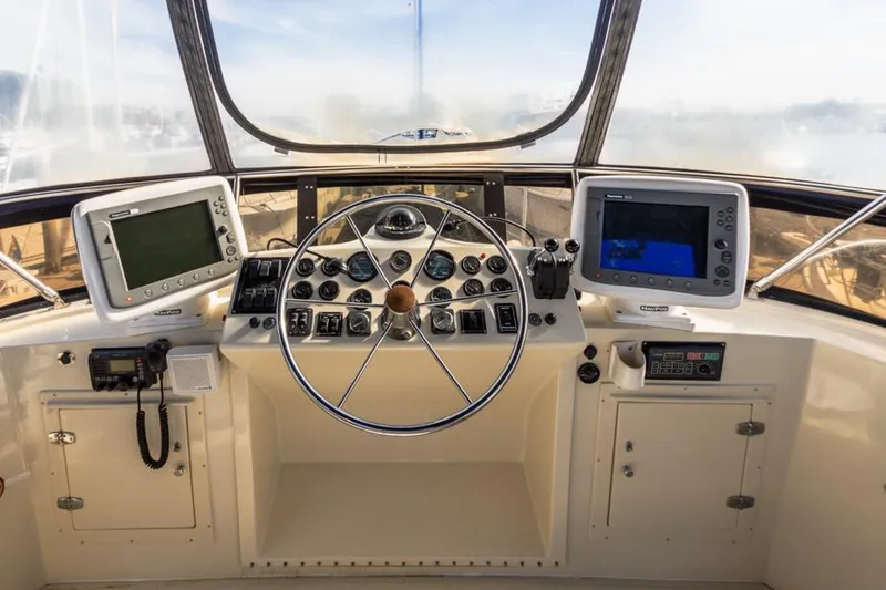 Slide: The Image of Helm of 1987 Californian 48 Convertible yacht with navigation equipment and steering wheel. - 20