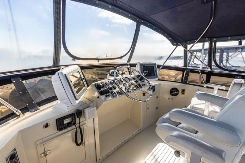 Slide: The Image of 1987 Californian 48 Convertible yacht helm with modern navigation equipment. - 23