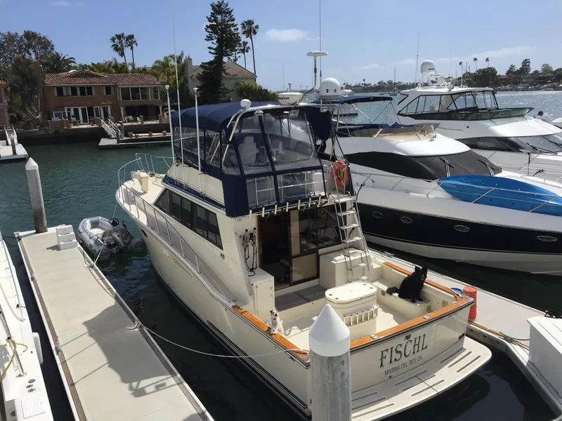 Slide: The Image of 1987 Californian 48 Convertible yacht docked at a marina. - 3
