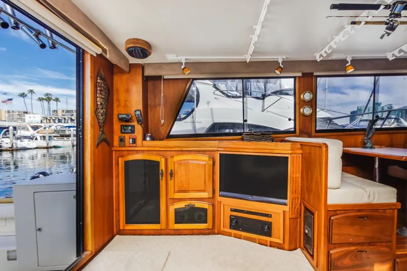 Slide: The Image of 1987 Californian 48 Convertible yacht interior with wooden cabinetry and marina view. - 31