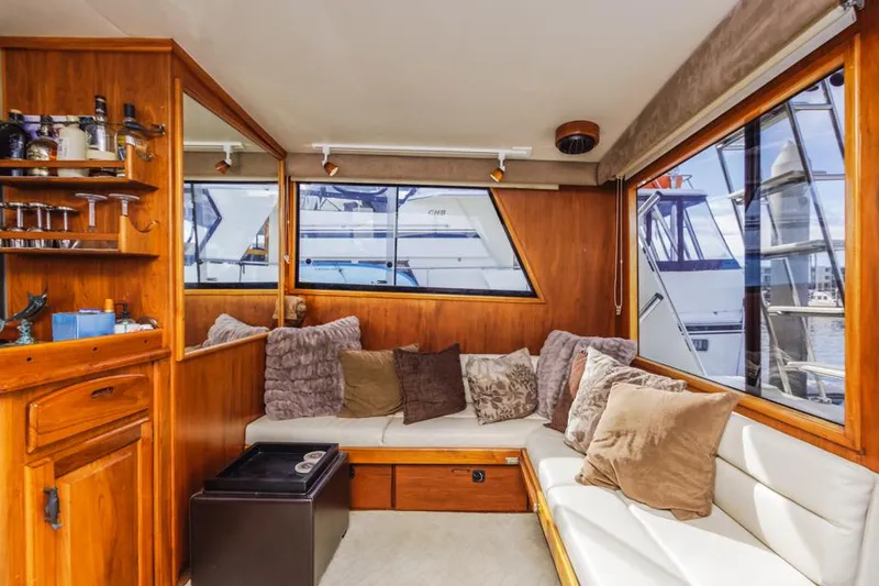 Slide: The Image of Interior of 1987 Californian 48 Convertible yacht with cozy seating and wooden cabinetry. - 32