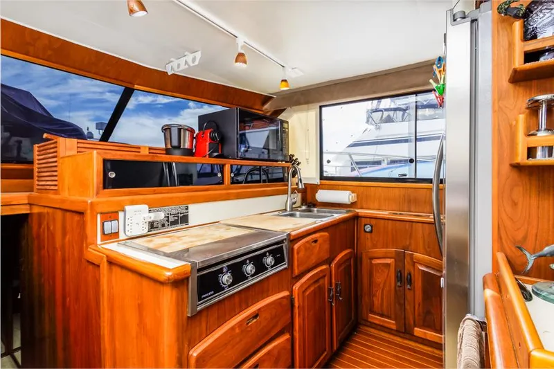 Slide: The Image of 1987 Californian 48 Convertible yacht kitchen with wooden cabinetry and modern appliances. - 36