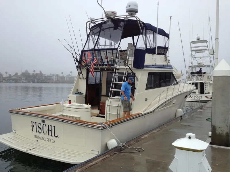 Slide: The Image of 1987 Californian 48 Convertible yacht docked at marina. - 4