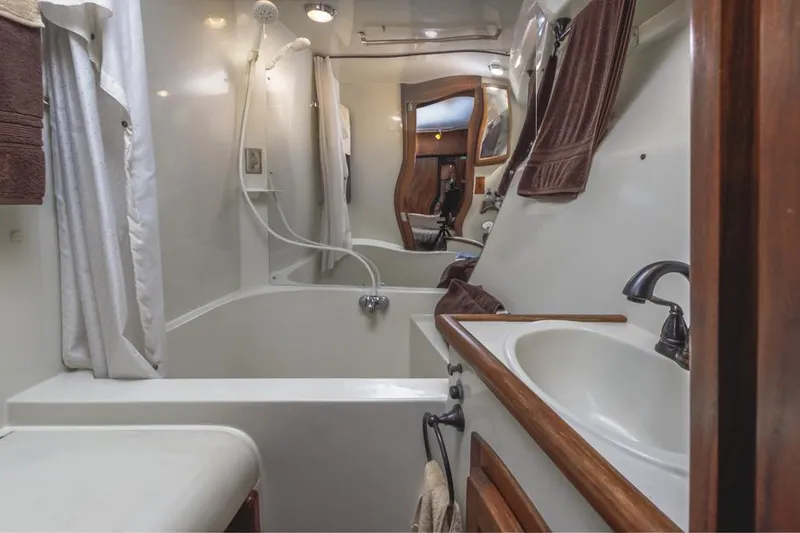 Slide: The Image of 1987 Californian 48 Convertible yacht bathroom with shower, sink, and mirror. - 43
