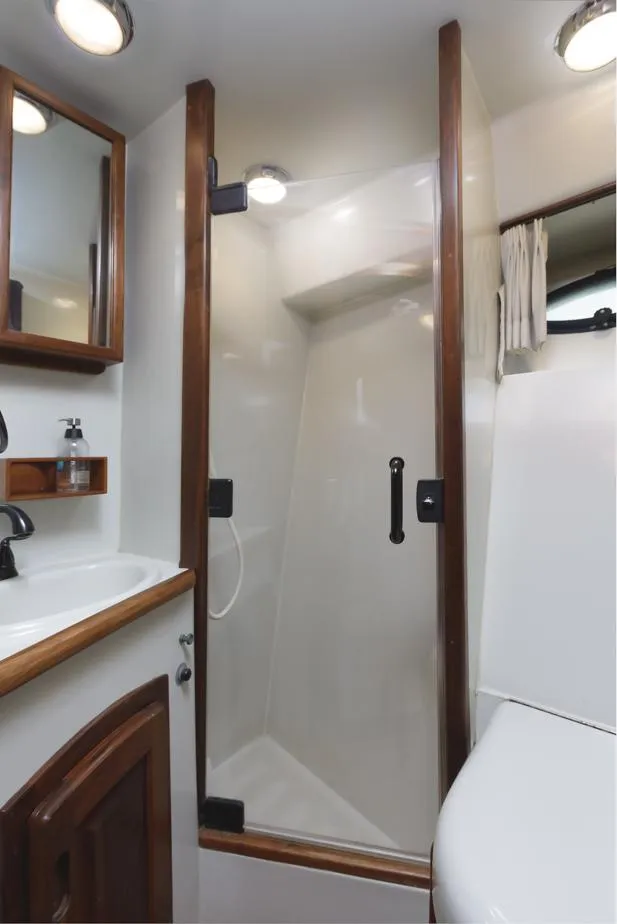 Slide: The Image of 1987 Californian 48 Convertible yacht bathroom with shower, sink, and toilet. - 45