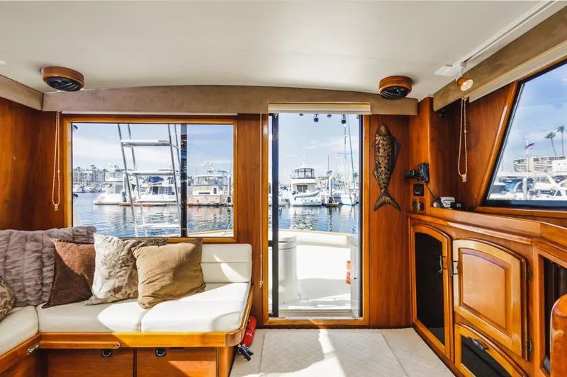 Slide: The Image of Interior of 1987 Californian 48 Convertible yacht with marina view. - 49