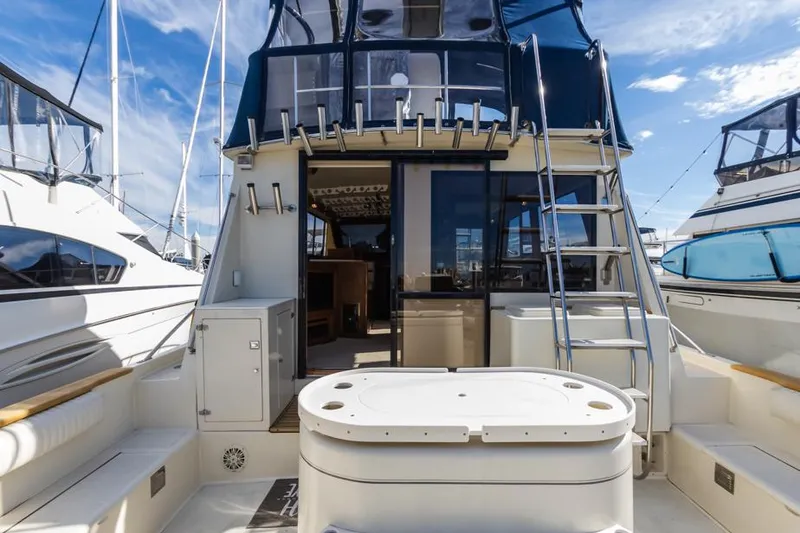 Slide: The Image of 1987 Californian 48 Convertible yacht stern view with ladder and seating area. - 9