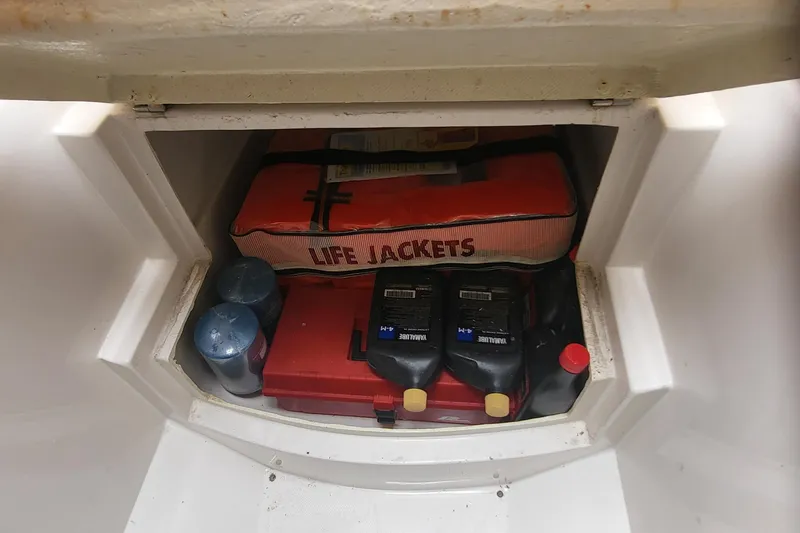 Slide: The Image of Storage compartment in Jupiter 31 Center Console boat with life jackets and supplies. - 10