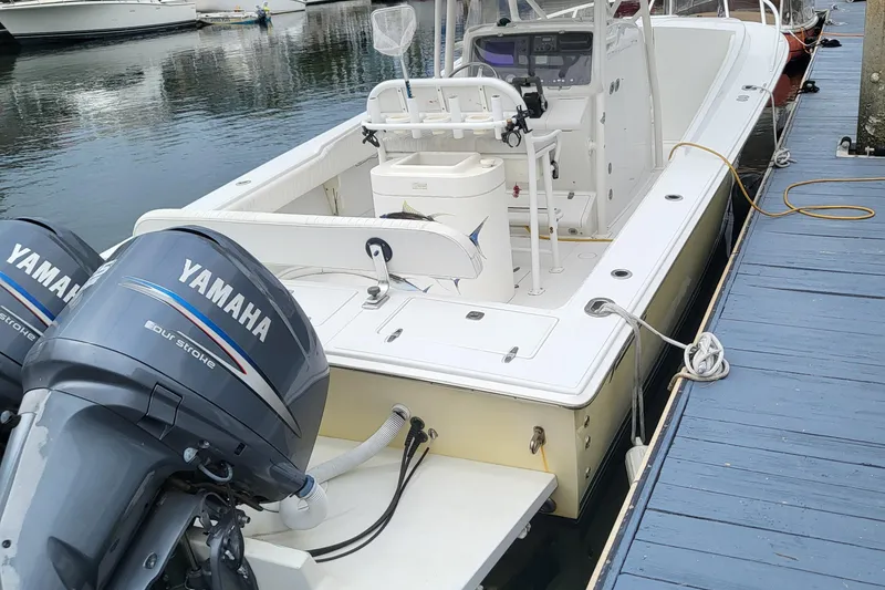 Slide: The Image of 2004 Jupiter 31 Center Console boat with Yamaha engines at dock. - 4