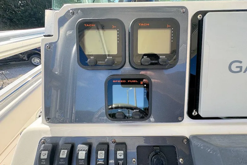 Slide: The Image of 2007 Robalo R240 Center Console dashboard with Yamaha gauges and Garmin device. - 10