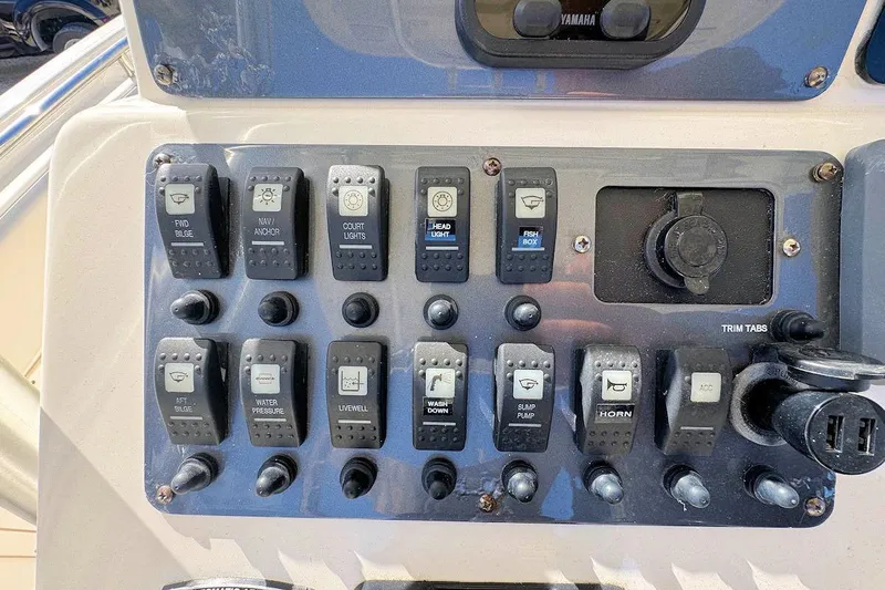 Slide: The Image of Control panel of a 2007 Robalo R240 Center Console boat with various switches and dials. - 11