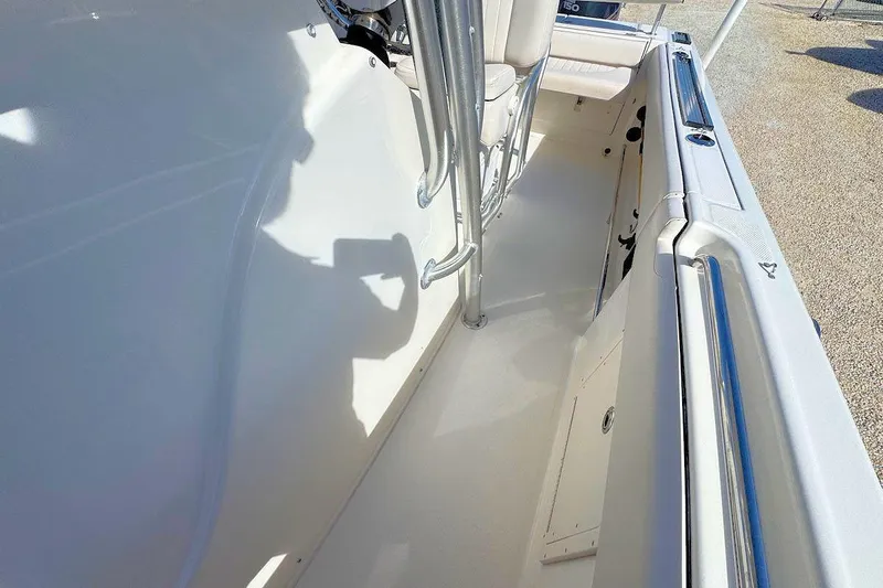 Slide: The Image of 2007 Robalo R240 Center Console boat interior with seating and stainless steel railings. - 12