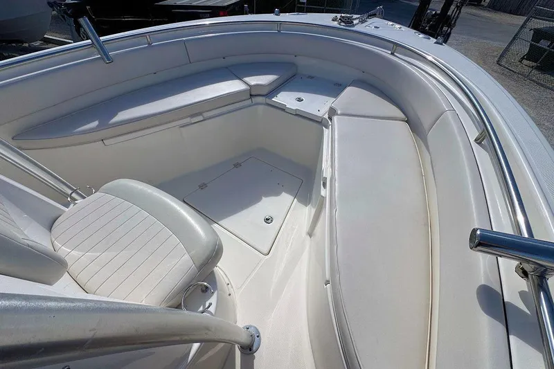 Slide: The Image of 2007 Robalo R240 Center Console boat interior with white seating and stainless steel railings. - 13